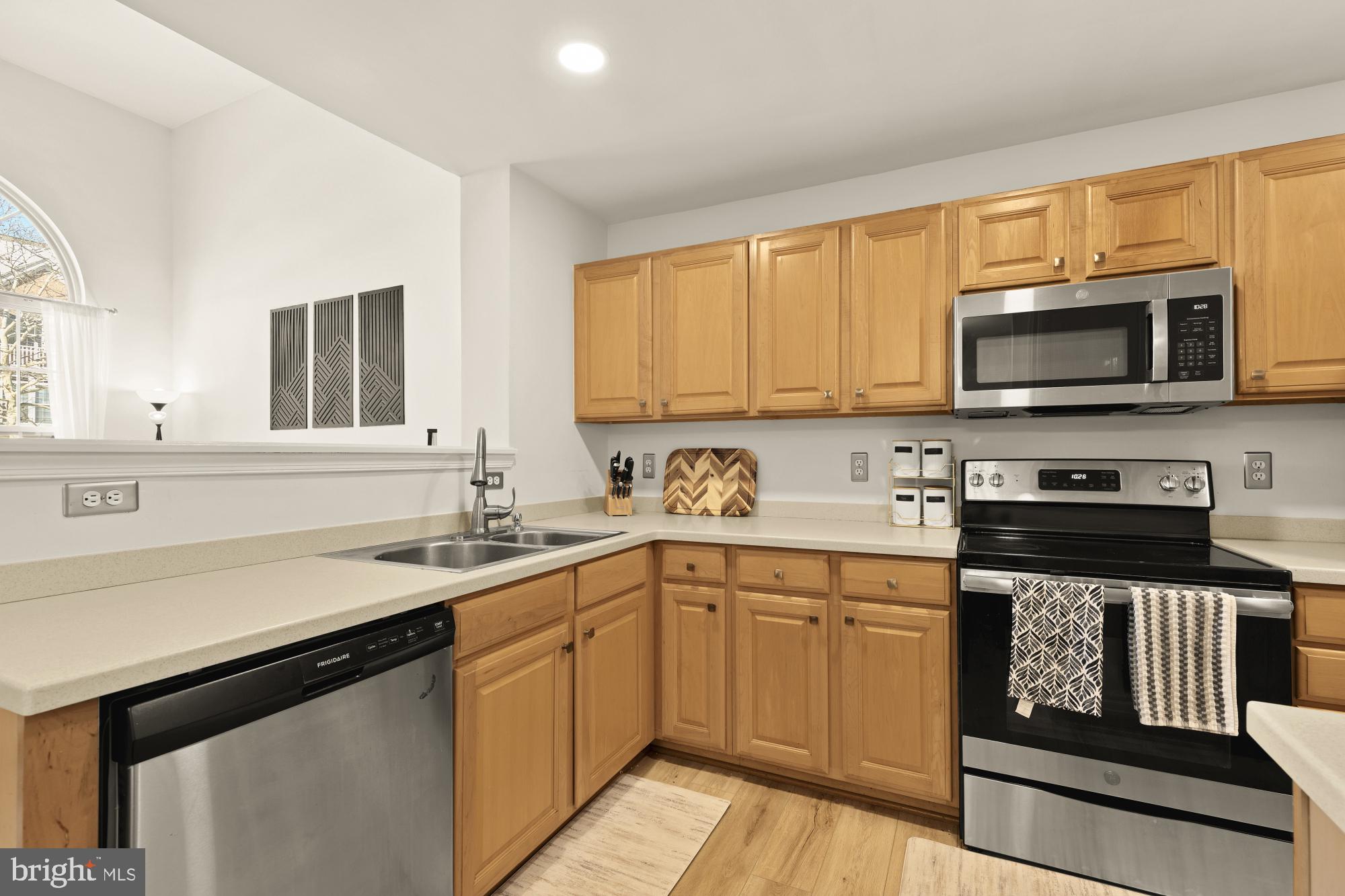 1887 Crescent Park Drive, Unit 111A Reston, VA 20190 - Photo 9 of 27 a kitchen with a sink stove and microwave