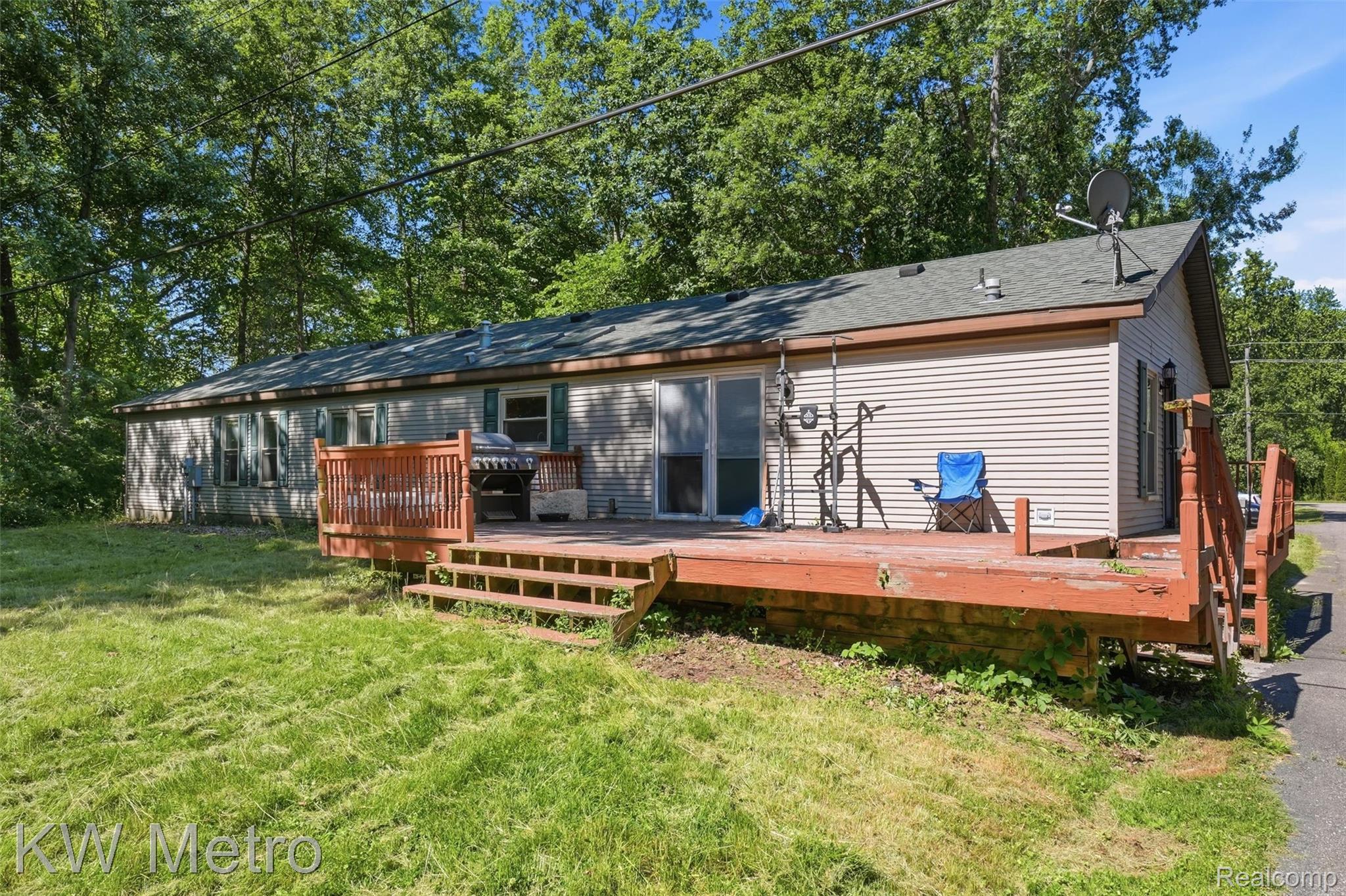 22733 Sumpter Road Belleville, MI 48111 - Photo 32 of 52 Single-story residence featuring light-colored horizontal siding and a dark shingled roof