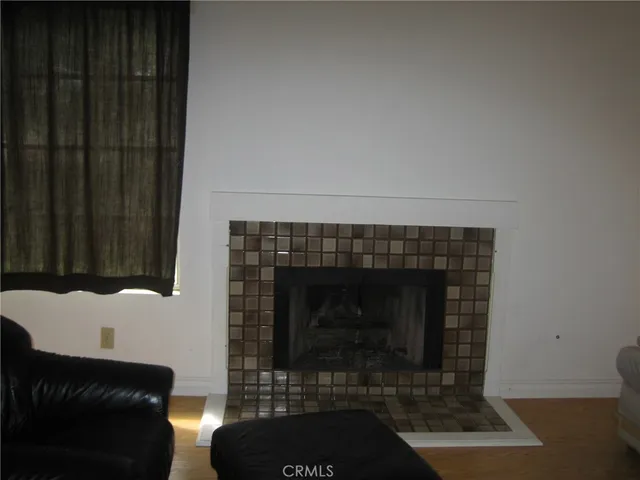a living room with furniture a rug and a fireplace