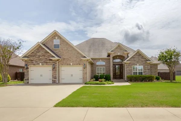 a front view of house with yard and green space