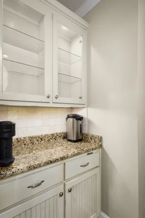 a kitchen with granite countertop a sink and cabinets