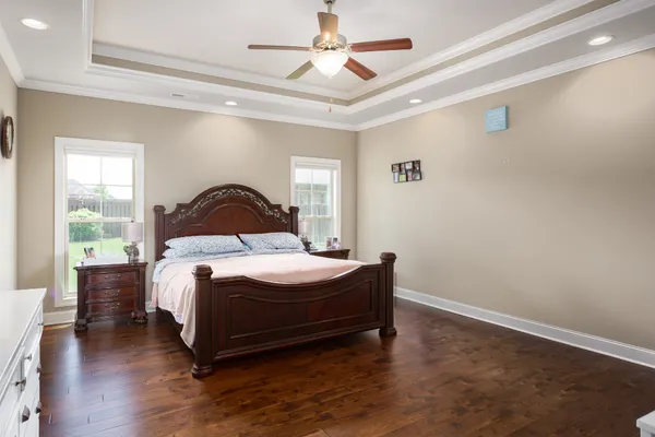 a bedroom with a bed and wooden floor