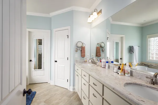 a spacious bathroom with a double vanity sink mirror and shower