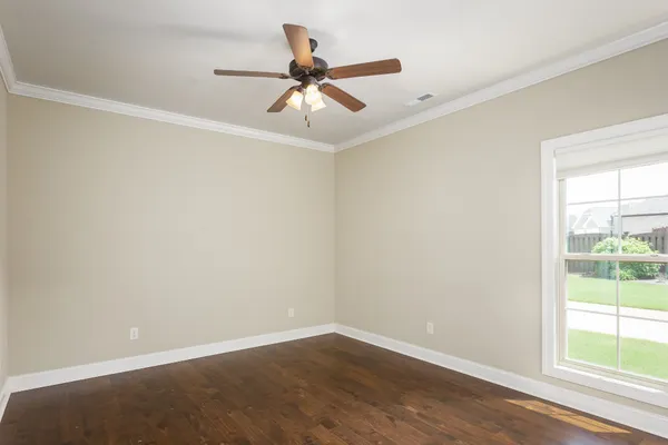 a view of a big room with wooden floor closet and windows