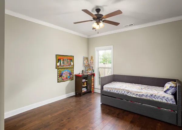 a bedroom with a bed and a chandelier