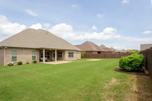a view of a house with a garden and plants