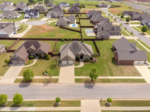 an aerial view of a house with a yard