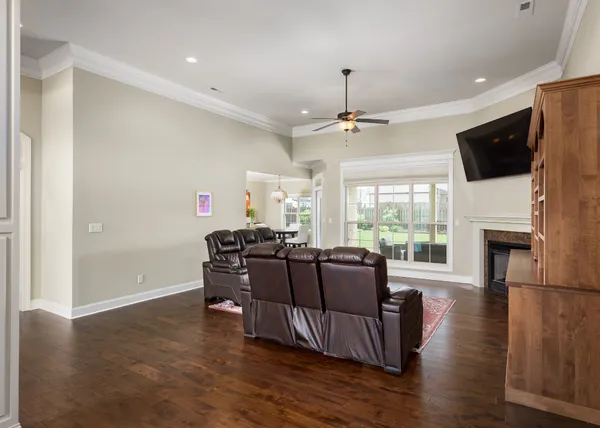 a living room with furniture fireplace and flat screen tv