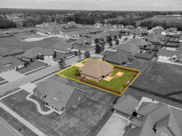 an aerial view of a pool with chairs