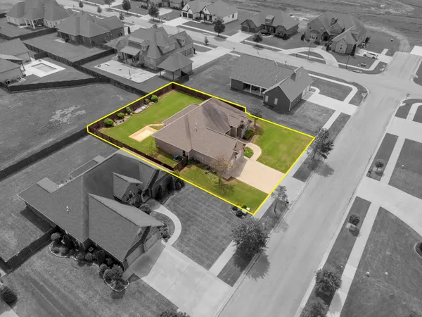 an aerial view of a swimming pool with outdoor seating