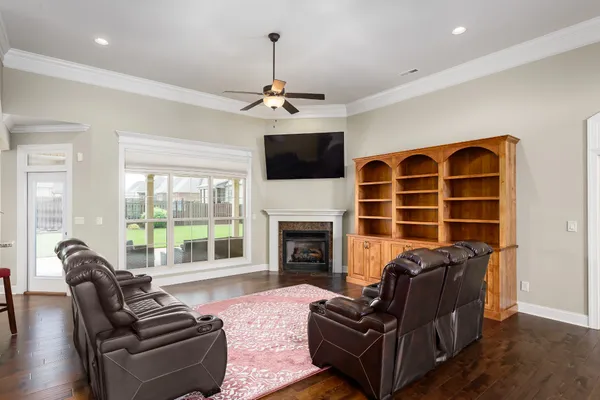 a living room with furniture a fireplace and a flat screen tv