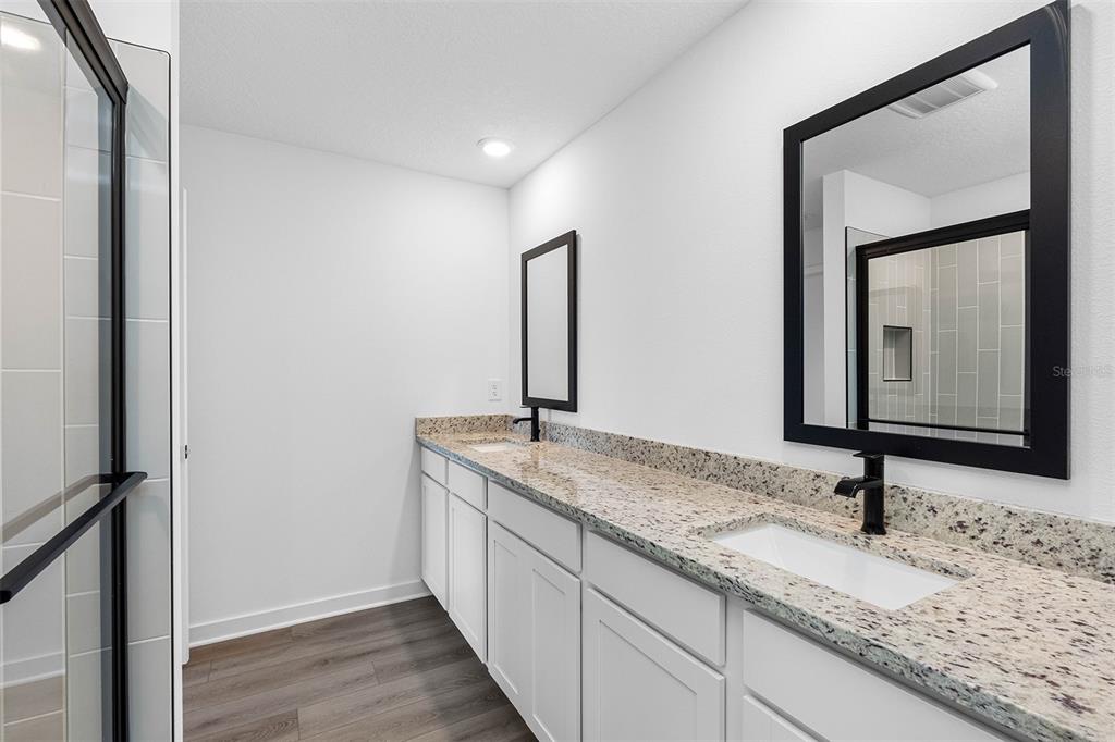 5466 Parnell Avenue Spring Hill, FL 34608 - Photo 6 of 7 a bathroom with a granite countertop sink and a mirror