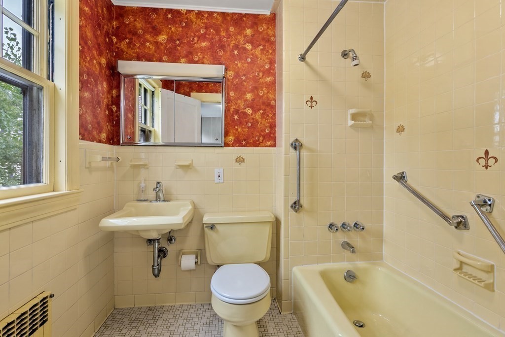 7 Pleasant Street Wellesley, MA 02482 - Photo 11 of 23 a bathroom with a sink toilet mirror and shower