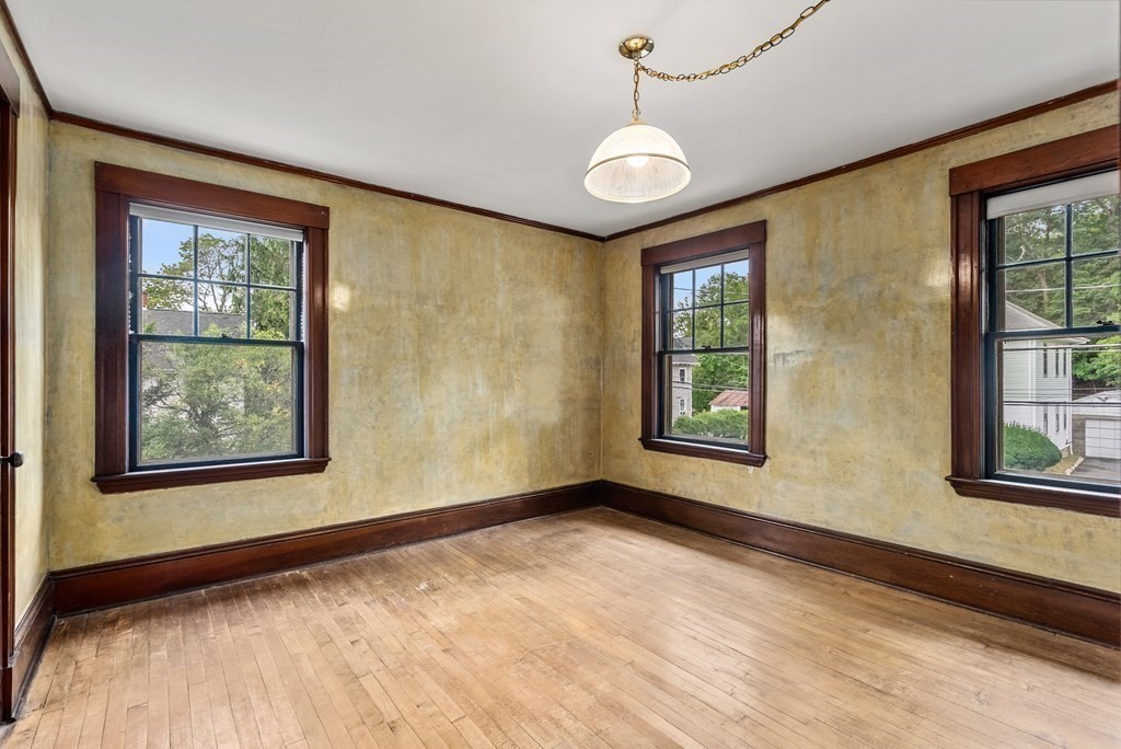 7 Pleasant Street Wellesley, MA 02482 - Photo 13 of 23 a view of an empty room with a window and wooden floor