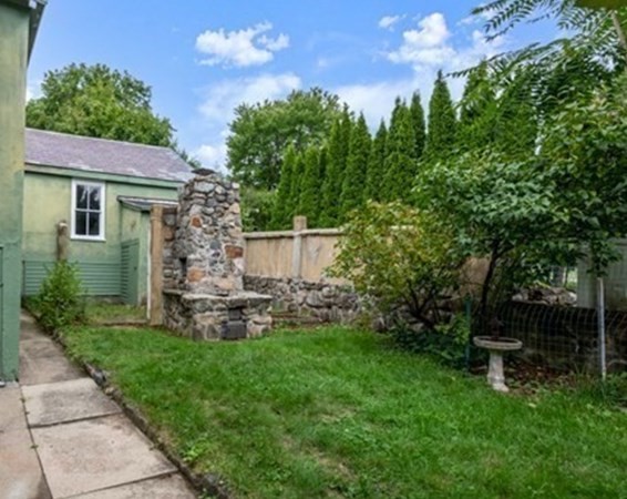 7 Pleasant Street Wellesley, MA 02482 - Photo 21 of 23 a view of a chair and table in backyard of the house