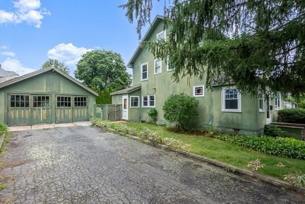 7 Pleasant Street Wellesley, MA 02482 - Photo 22 of 23 a front view of a house with a garden