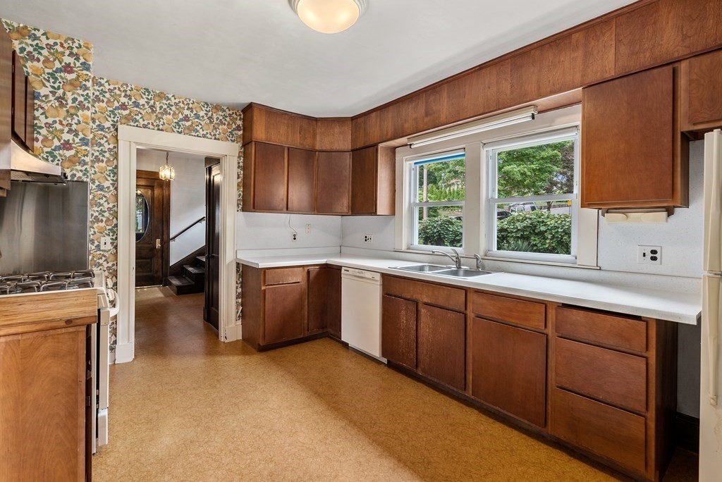 7 Pleasant Street Wellesley, MA 02482 - Photo 4 of 23 a kitchen with sink cabinets and wooden floor
