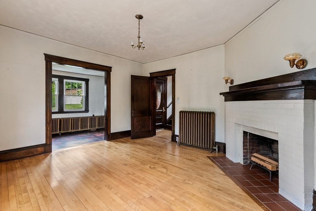 7 Pleasant Street Wellesley, MA 02482 - Photo 9 of 23 a view of a livingroom with a fireplace a ceiling fan and windows