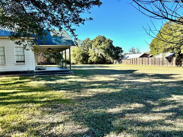 a swimming pool with outdoor seating and yard