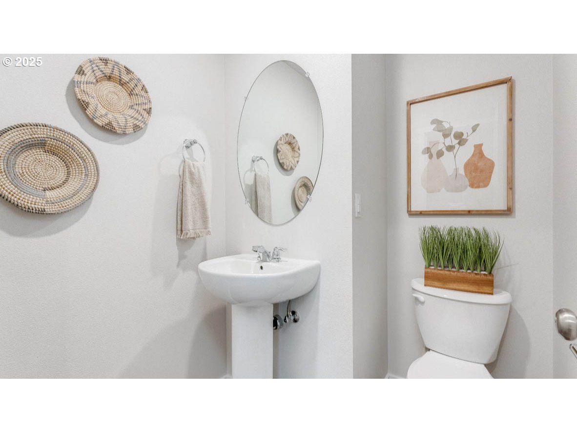 3441 Southwest Hartley Avenue Gresham, OR 97080 - Photo 13 of 28 a bathroom with a toilet a sink and a mirror