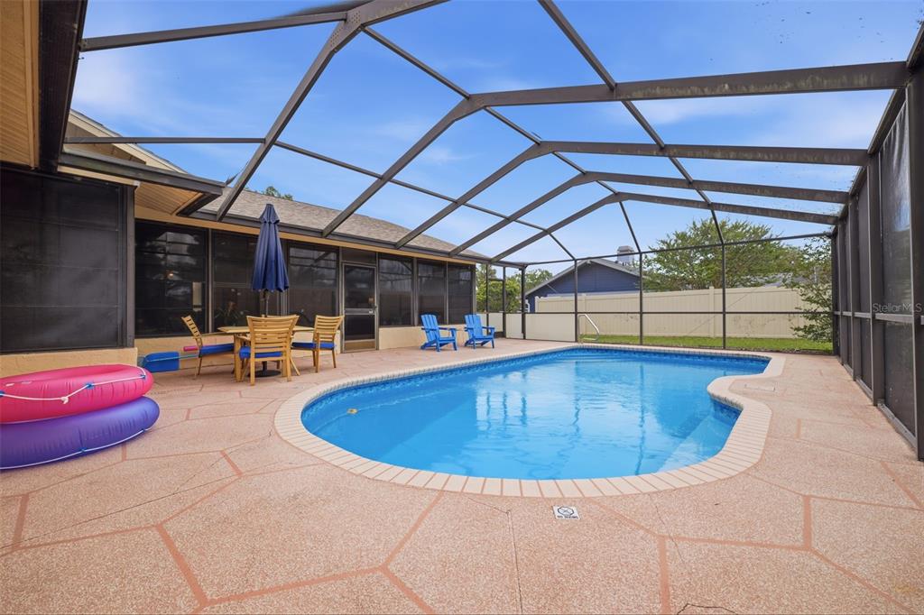 5227 Suwannee Road Weeki Wachee, FL 34607 - Photo 40 of 62 a view of a swimming pool with a lounge chair