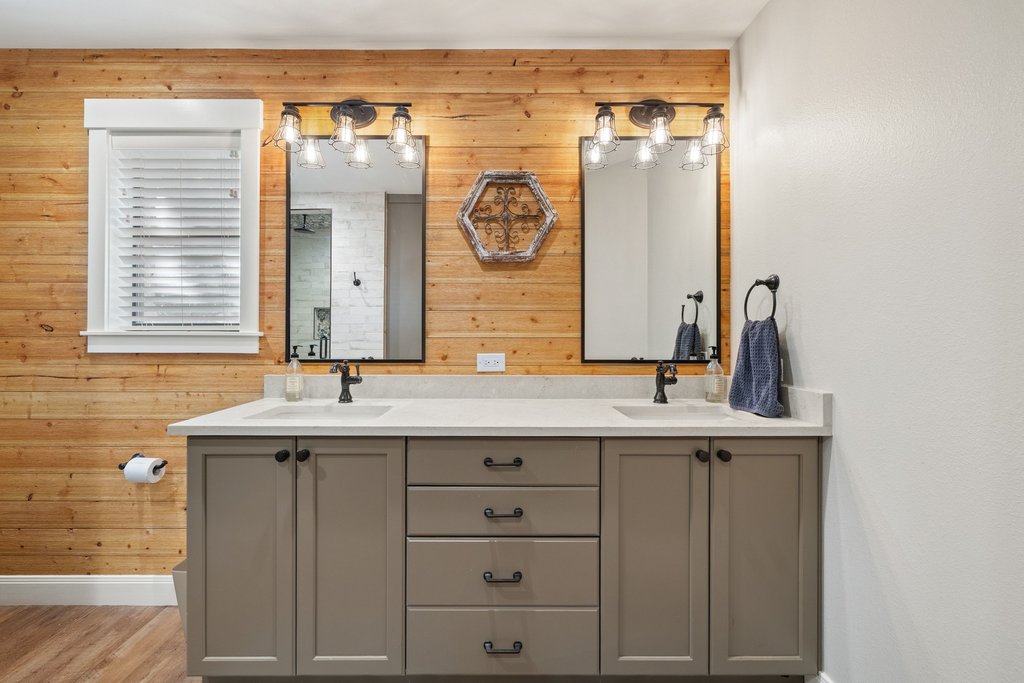 23644 Nameless Road Leander, TX 78641 - Photo 18 of 40 Double vanity with stone counters and dual mirrors creates a harmonious bath space.