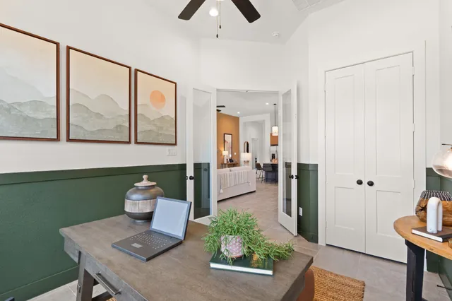 a view of a hallway with furniture and a potted plant