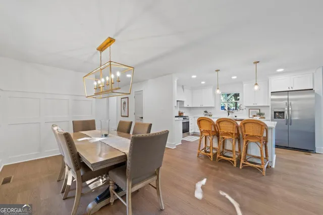 a dining room with furniture and chandelier