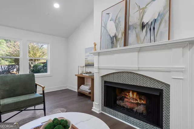 a living room with furniture a window and a fireplace
