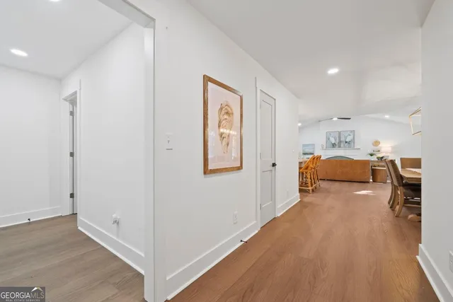 a view of living room with furniture and wooden floor