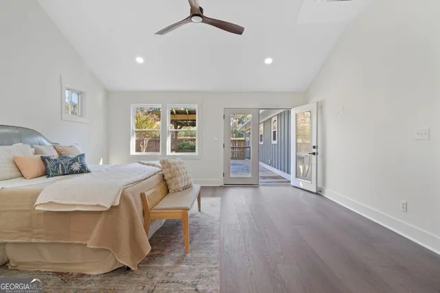 a spacious bedroom with a large bed and a wooden floor
