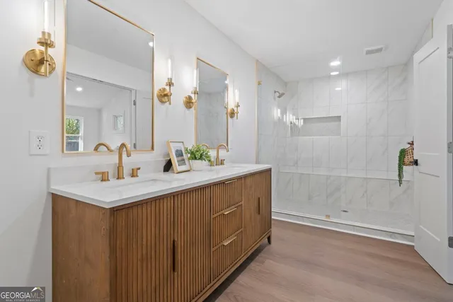 a bathroom with a sink a mirror and a shower