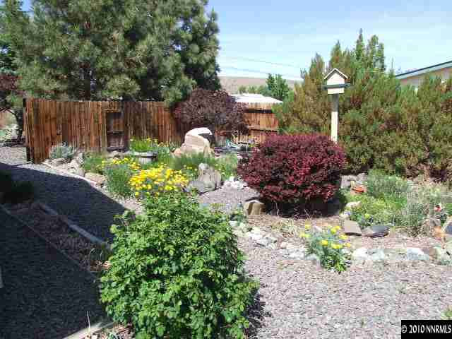 17485 Fantail Street Reno, NV 89508 - Photo 2 of 13 a view of a garden with a bench