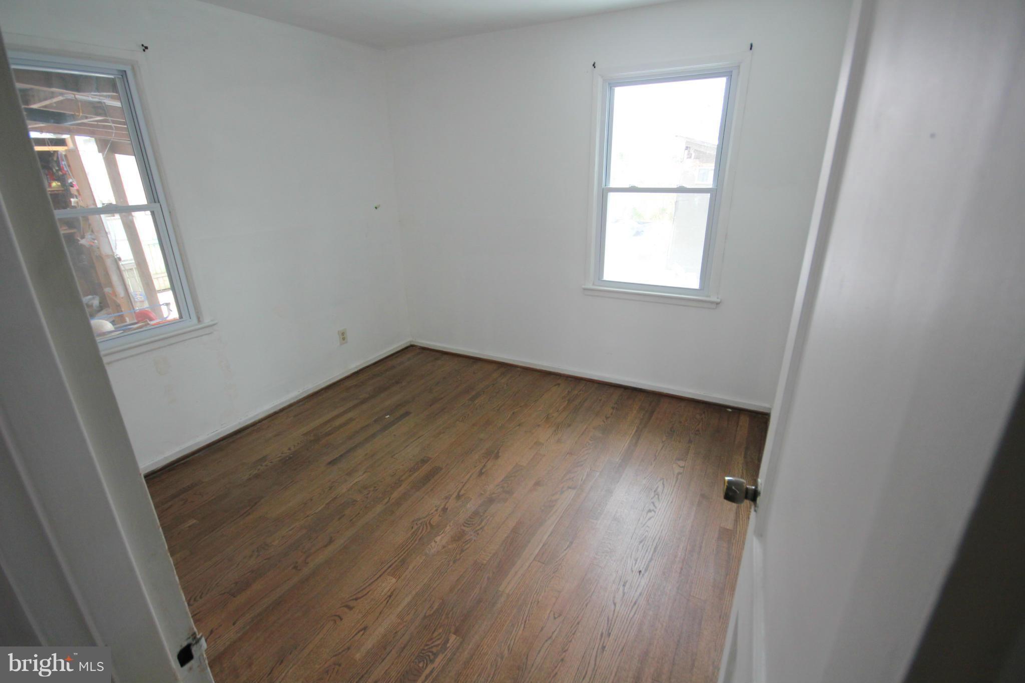 12305 Bluhill Road Silver Spring, MD 20902 - Photo 4 of 4 an empty room with wooden floor and windows