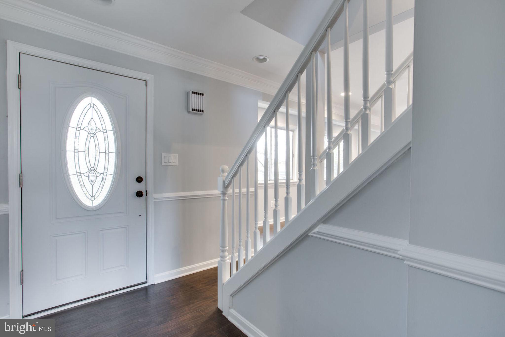 14312 Sturtevant Road Silver Spring, MD 20905 - Photo 2 of 43 a view of staircase with railing and a chandelier