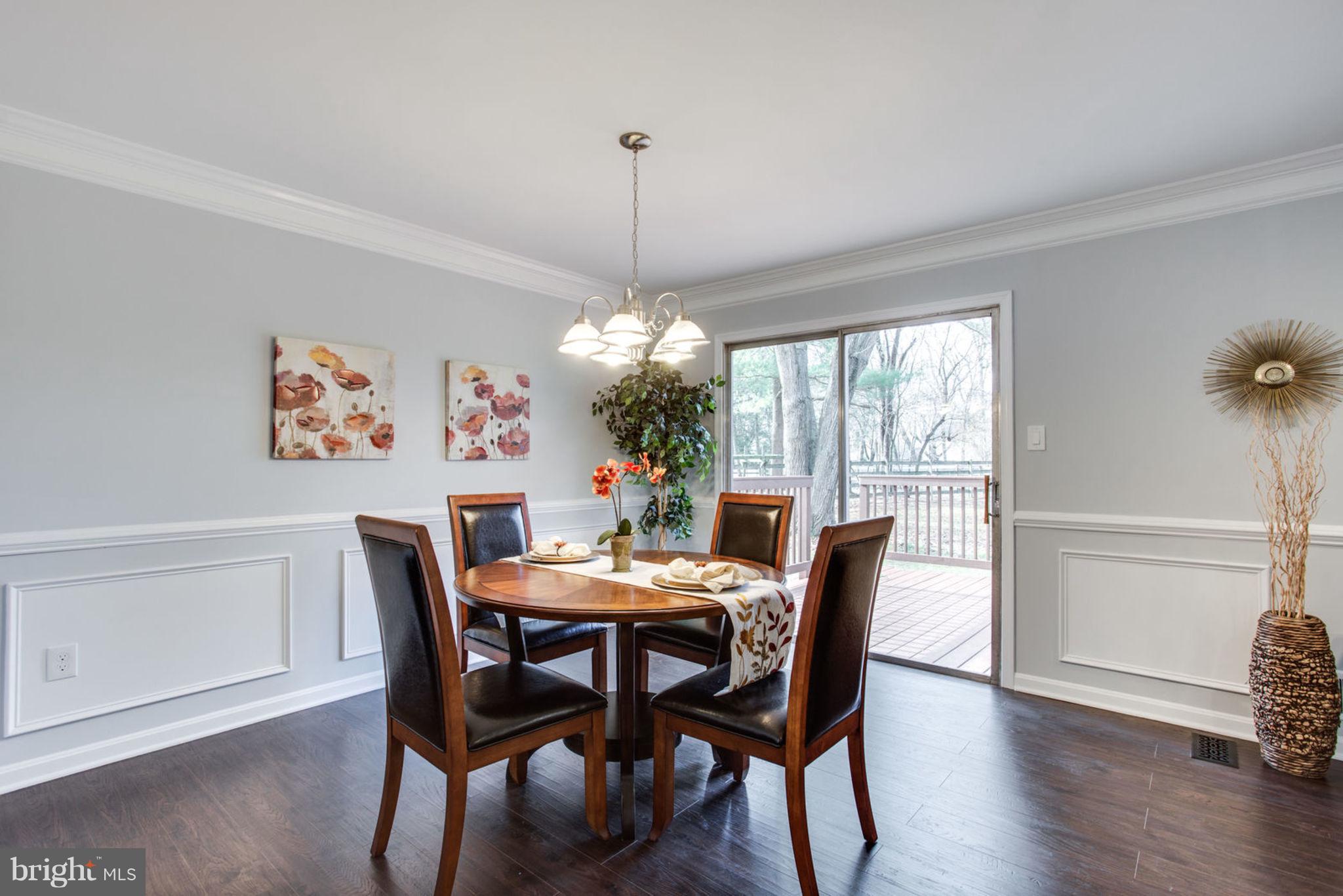 14312 Sturtevant Road Silver Spring, MD 20905 - Photo 12 of 43 a dining room with furniture a chandelier and wooden floor
