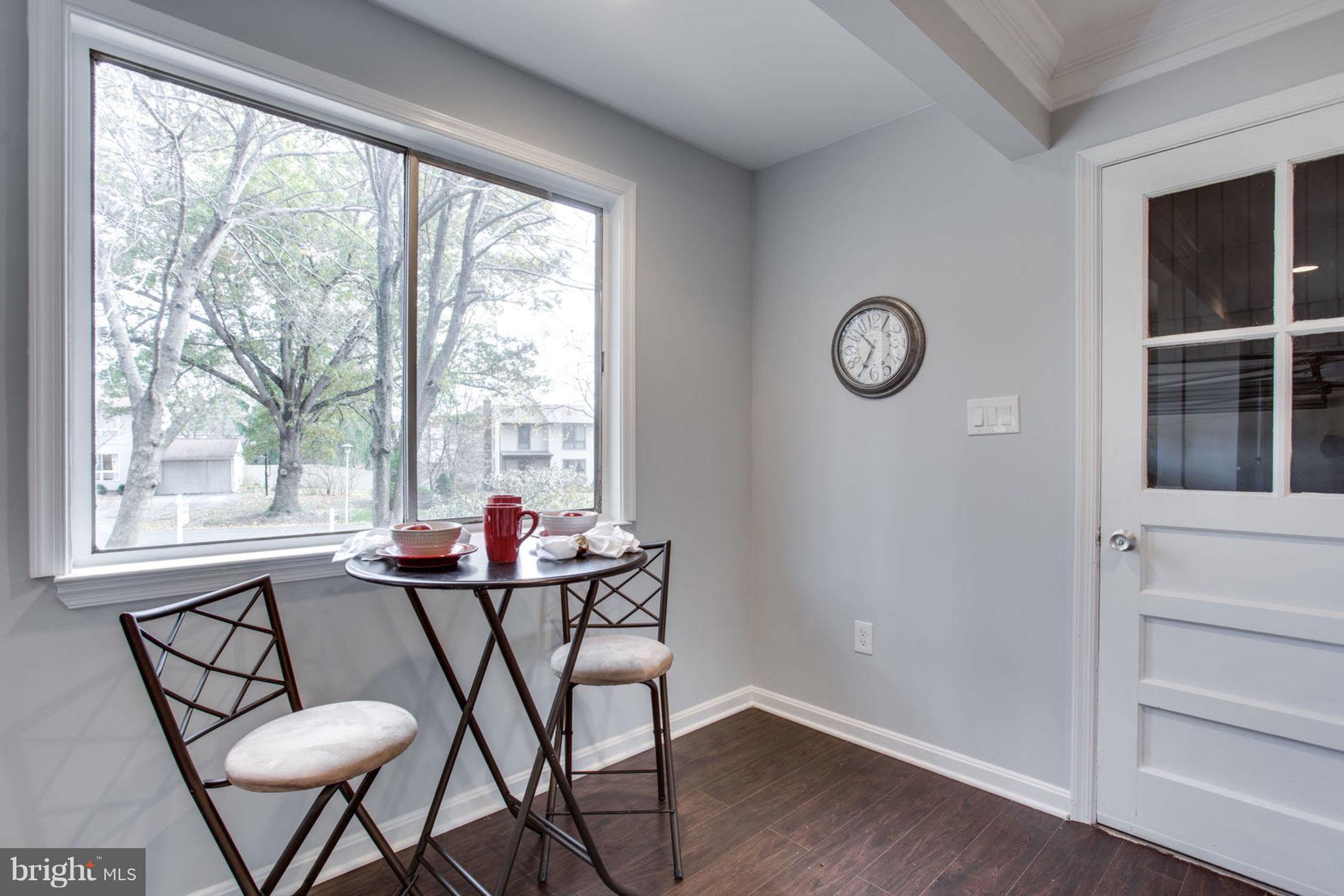 14312 Sturtevant Road Silver Spring, MD 20905 - Photo 18 of 43 a view of a room that has a table and chair with wooden floor