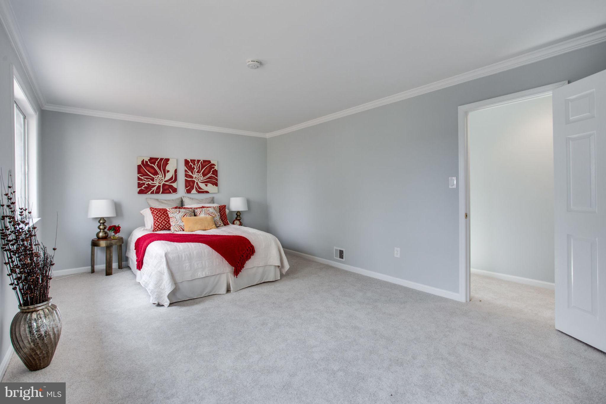 14312 Sturtevant Road Silver Spring, MD 20905 - Photo 20 of 43 a bedroom with a bed and a painting on the wall