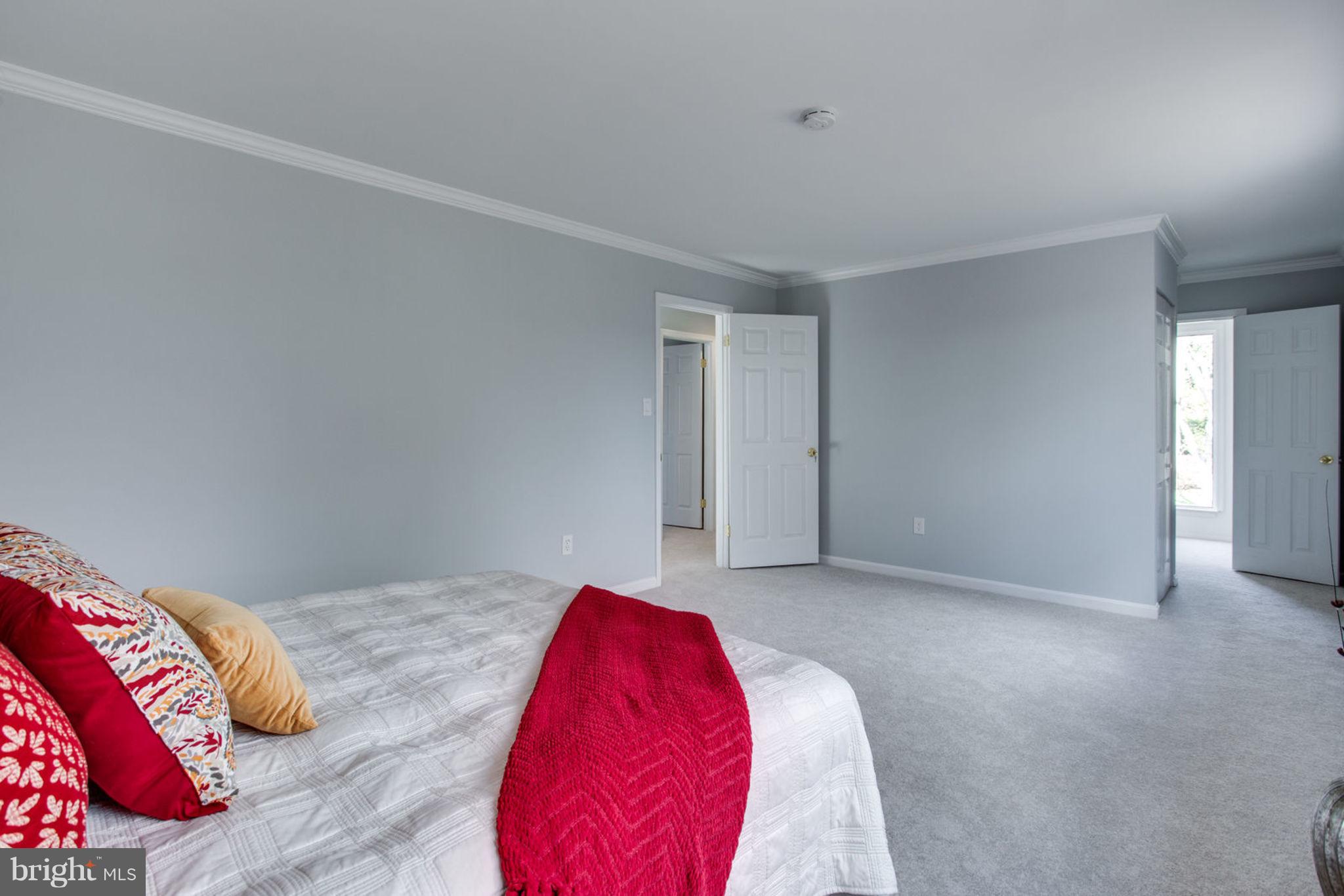 14312 Sturtevant Road Silver Spring, MD 20905 - Photo 21 of 43 a view of a bedroom with a bed and a couch
