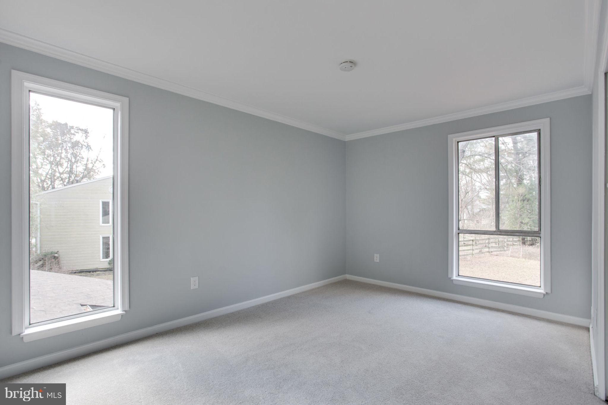 14312 Sturtevant Road Silver Spring, MD 20905 - Photo 22 of 43 an empty room with windows and closet