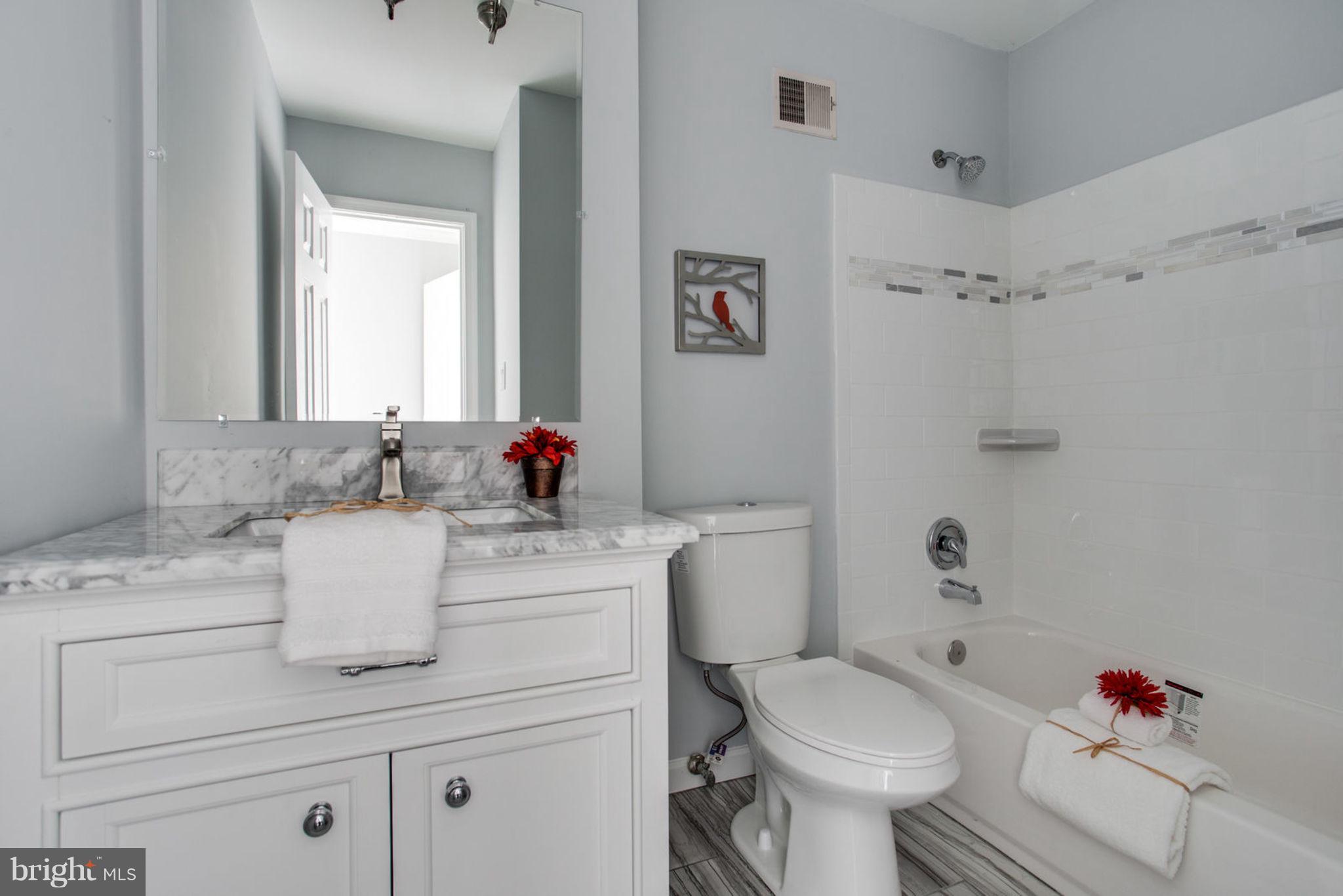 14312 Sturtevant Road Silver Spring, MD 20905 - Photo 24 of 43 a bathroom with a sink toilet and shower