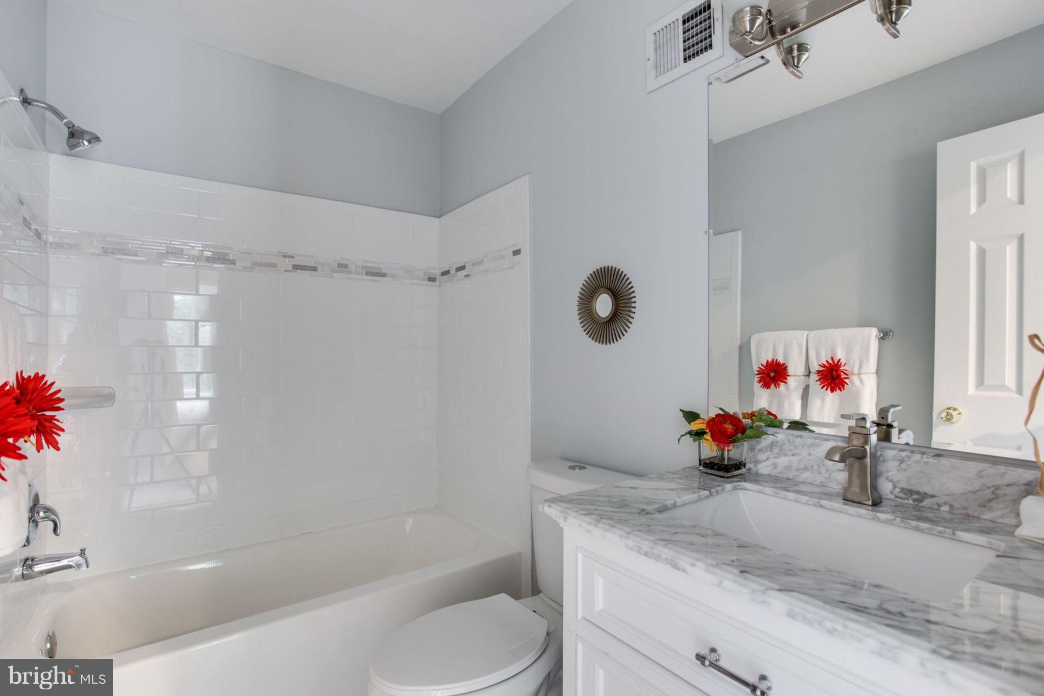 14312 Sturtevant Road Silver Spring, MD 20905 - Photo 28 of 43 a bathroom with a tub sink mirror and shower