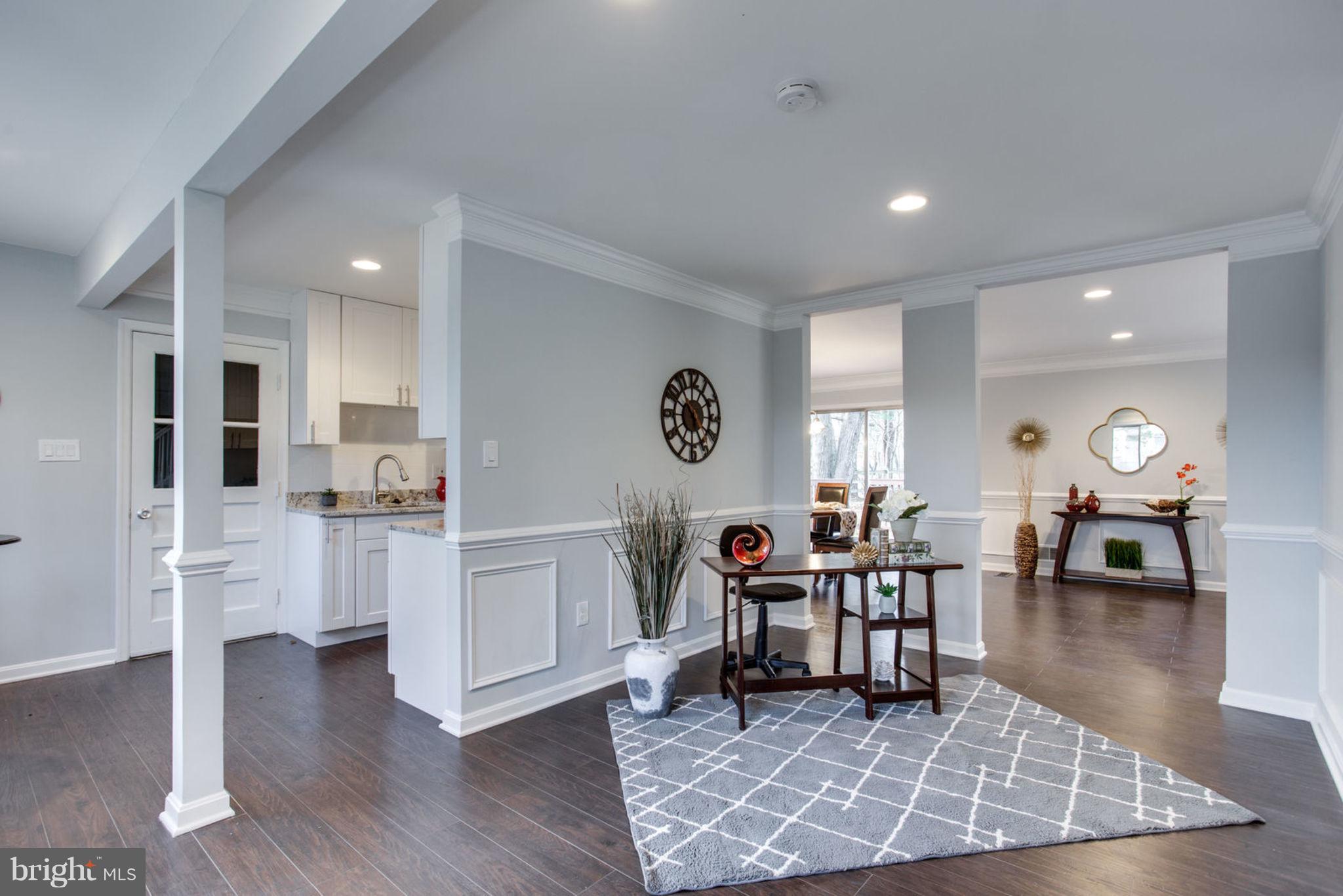 14312 Sturtevant Road Silver Spring, MD 20905 - Photo 5 of 43 a living room with furniture and a dining table with wooden floor