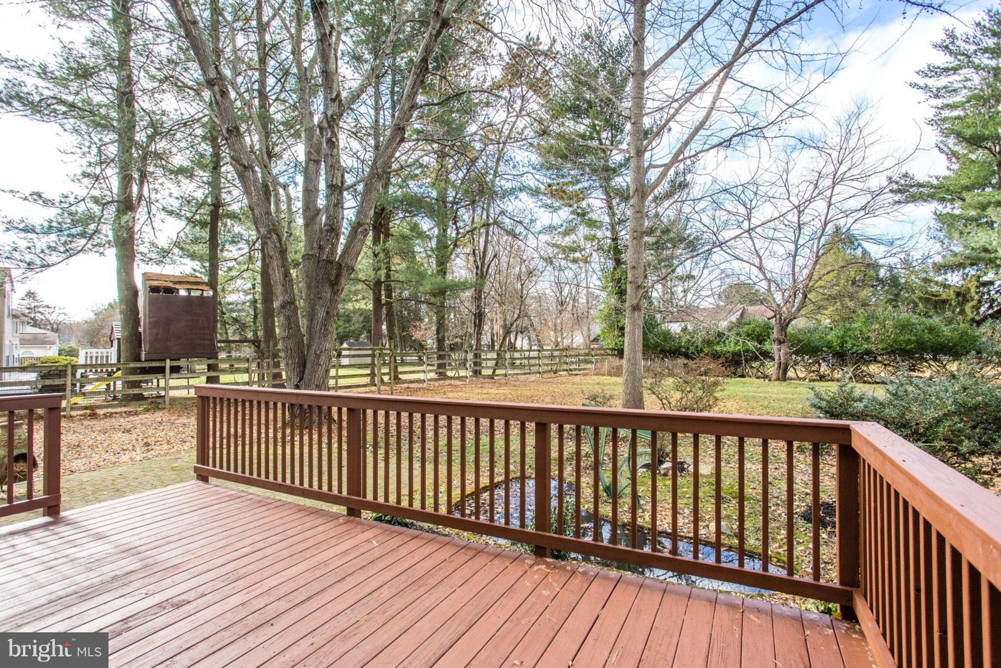 14312 Sturtevant Road Silver Spring, MD 20905 - Photo 42 of 43 a view of a wooden deck with trees