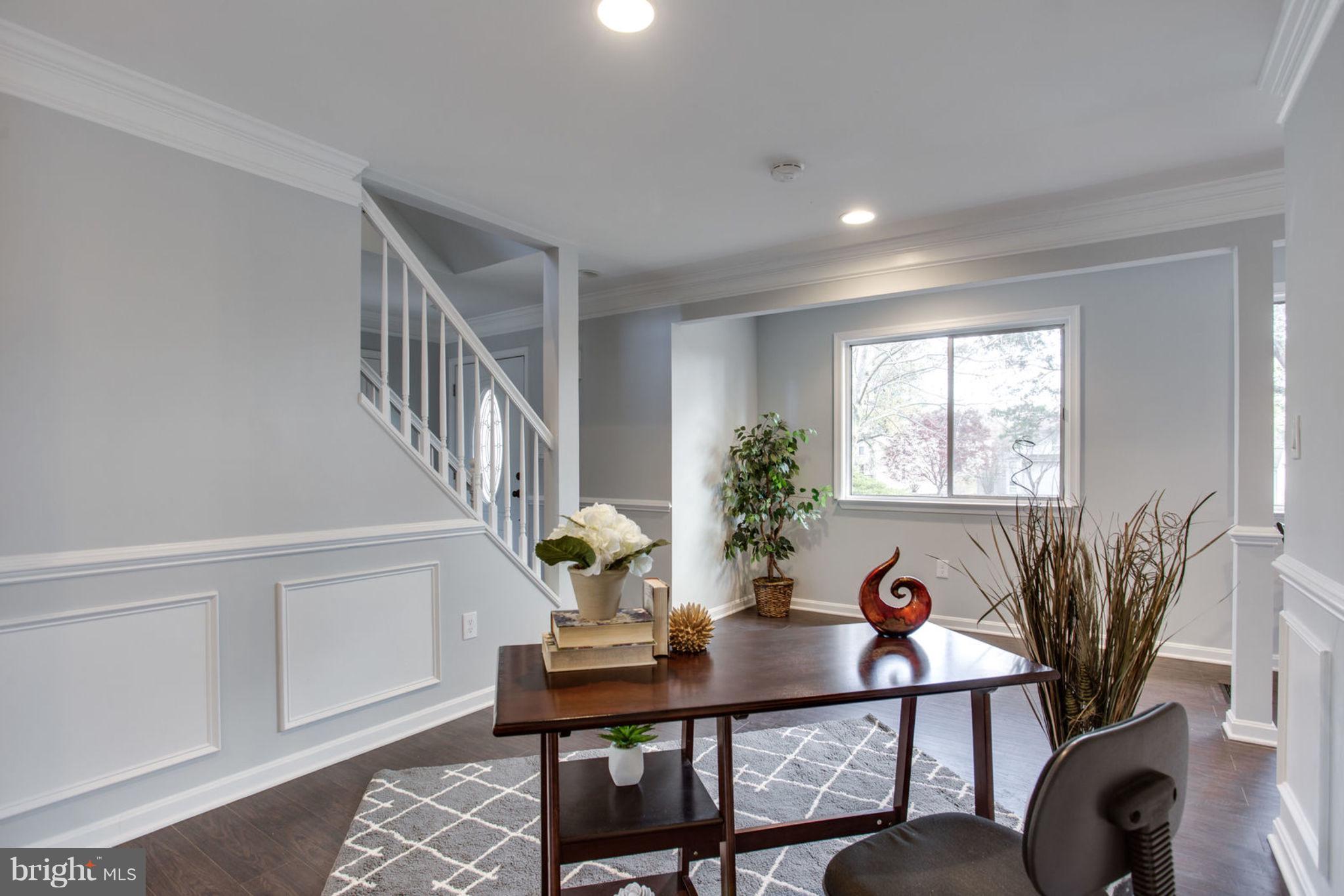 14312 Sturtevant Road Silver Spring, MD 20905 - Photo 7 of 43 a view of a room with furniture and a potted plant