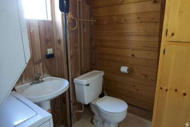 140 East Rim Road Duck Creek Village, UT 84762 - Photo 30 of 45 Half bathroom with wood walls, light floors, and washer / dryer