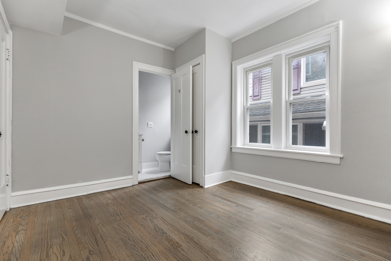 1032 North Austin Boulevard, Unit 1N Oak Park, IL 60302 - Photo 13 of 16 an empty room with wooden floor and windows