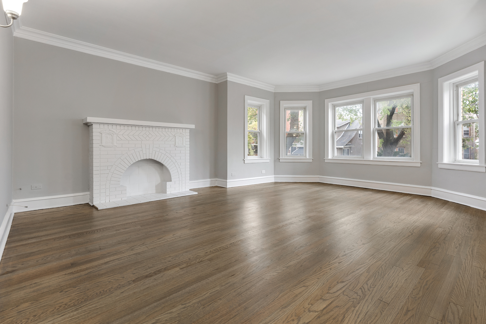 1032 North Austin Boulevard, Unit 1N Oak Park, IL 60302 - Photo 3 of 16 a view of empty room with wooden floor and fireplace
