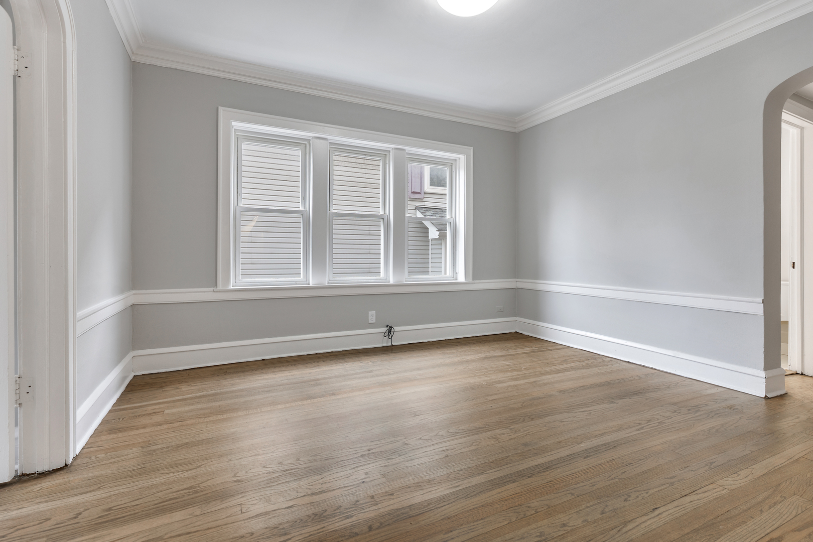 1032 North Austin Boulevard, Unit 1N Oak Park, IL 60302 - Photo 10 of 16 a view of an empty room with wooden floor and a window