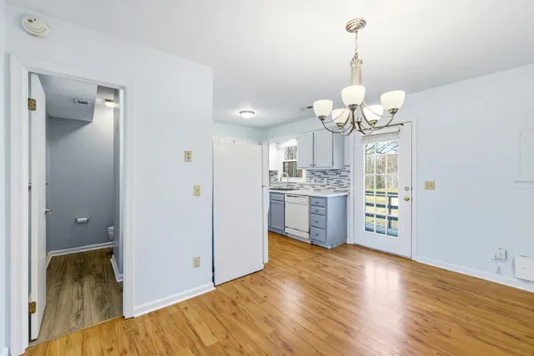 a view of a kitchen with stove and cabinets